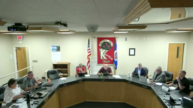 The council chamber on July 14, 2026, as City Attorney Scott Riggs, second from right, reports on the Kenyon Crossings contract.